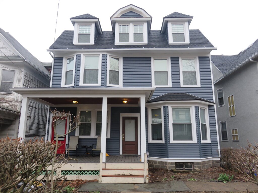 J N J Painting crew completing a professional exterior painting project on a residential home
